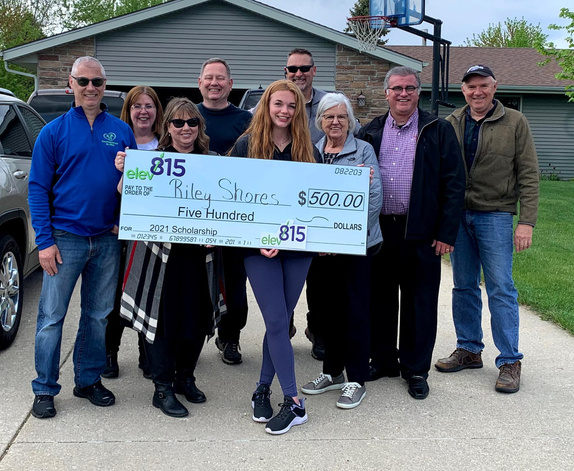 Business members pose with scholarship winner on her driveway
